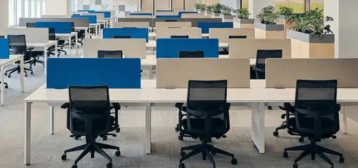 Modern open-plan office space featuring clean workstations, ergonomic chairs, and sanitized carpets provided by professional office cleaning services in Baltimore, MD.