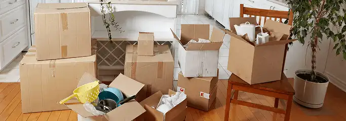 Packed moving boxes and household items in a kitchen before move-out or move-in cleaning, Baltimore, MD.
